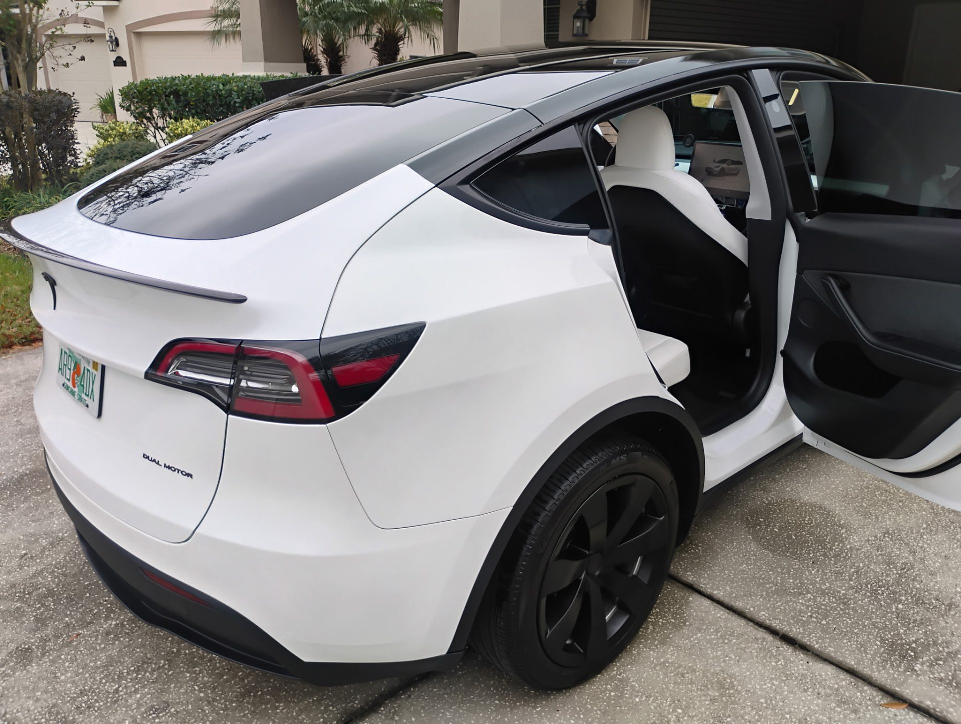 White car with open door

